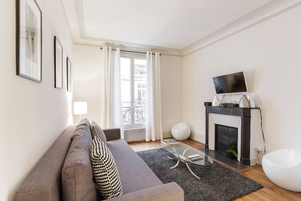 A bed Sofa with flat screen TV and fireplace