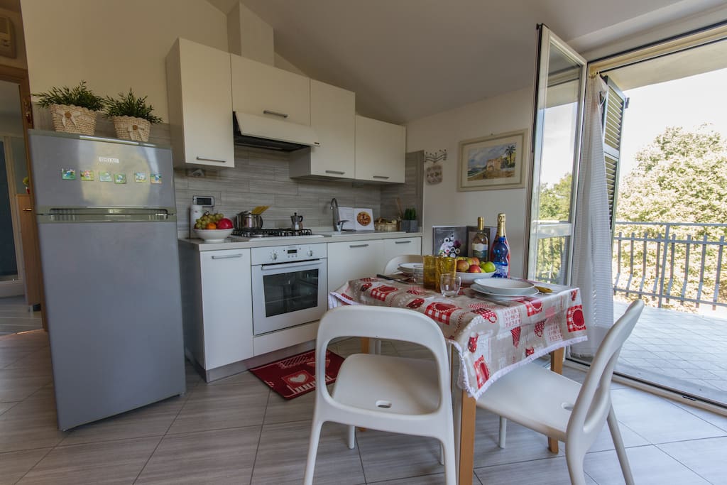 Living area with fully fitted kitchen, dining area and access to terrace.