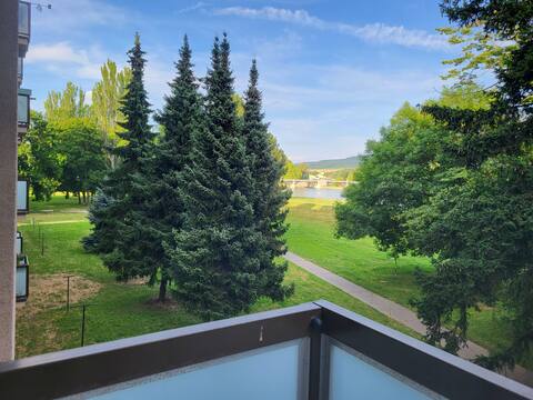 Apartment overlooking the water and greenery.