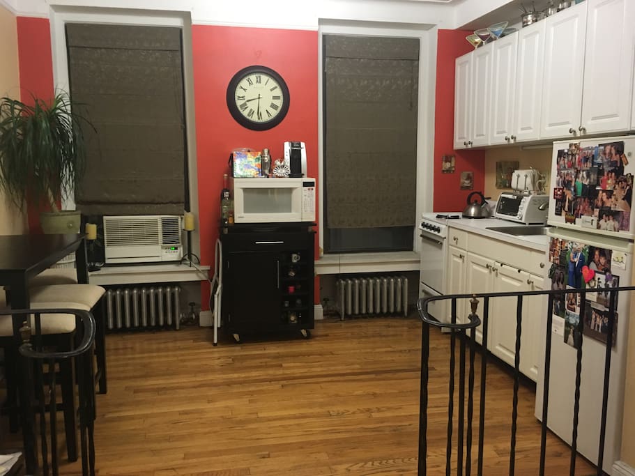 kitchen with full refrigerator, full size oven/stove, microwave, toaster oven, dining room table & 4 stools