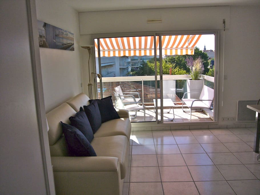Partie séjour et terrasse avec vue à gauche sur la plage