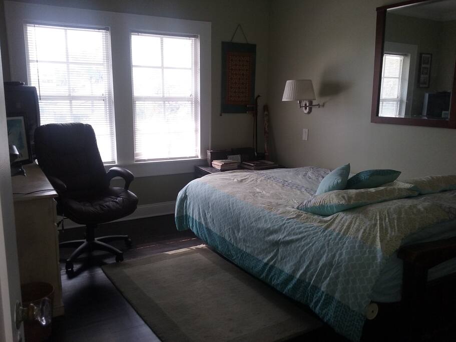 Second bedroom with desk and queen size bed.