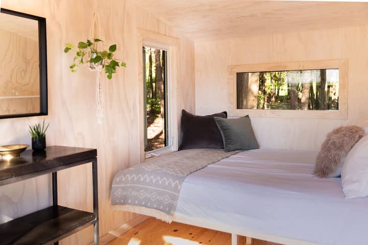 Our bunkie is nestled in the trees just steps from the house. It has a queen bed and is fully winterized.