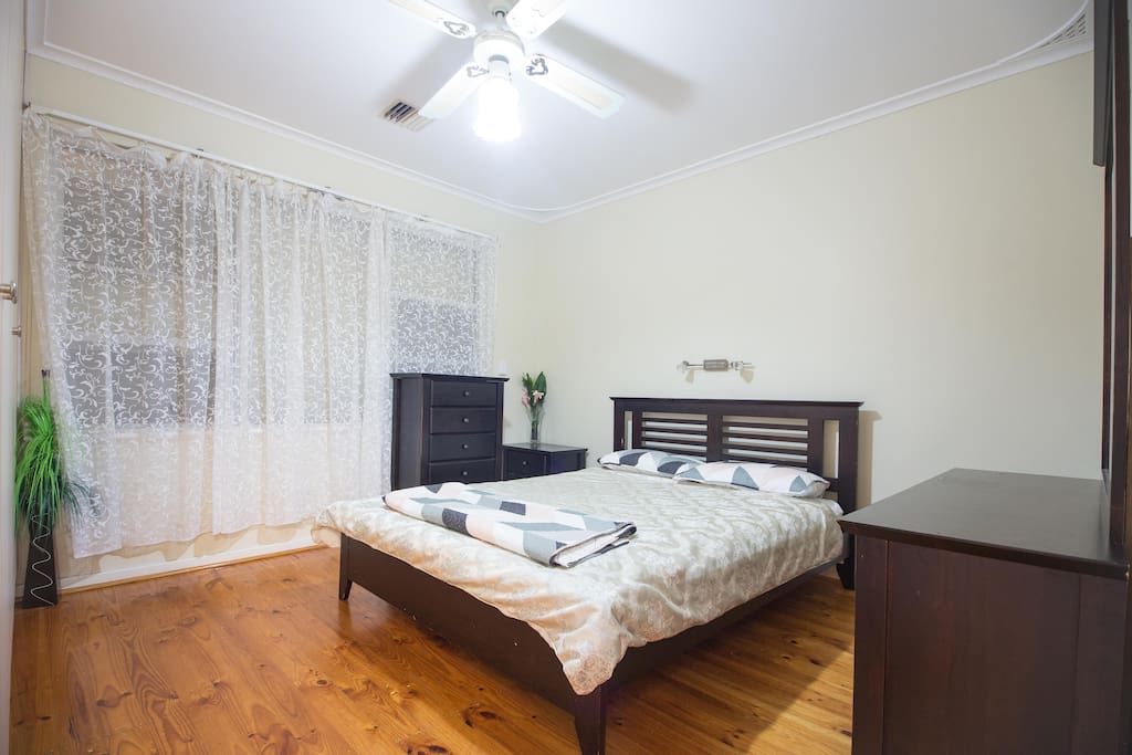 A queen size bed in room 1