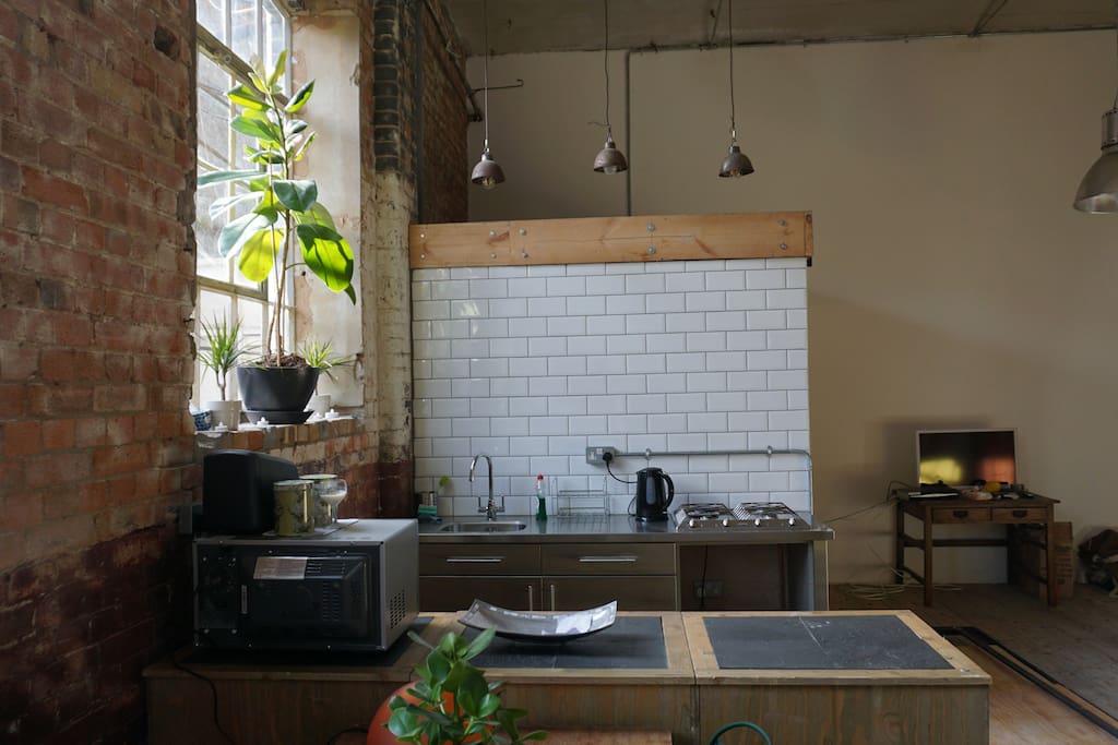 Kitchen area with metro tiles and vintage industrial lighting add to the look.