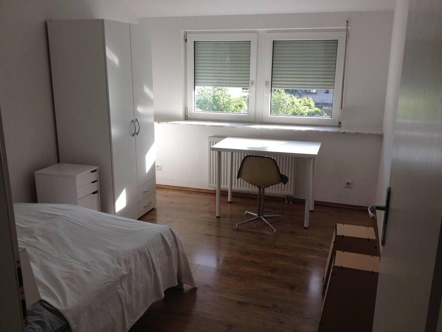 bedroom with cupboard, desk and chairs / Schlafzimmer mit Schrank, Schreibtisch, Stühlen und Hocker als Ablage