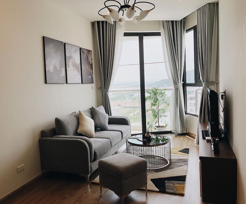 Living room with a comfortable sofa, cable TV and stunning view from balcony