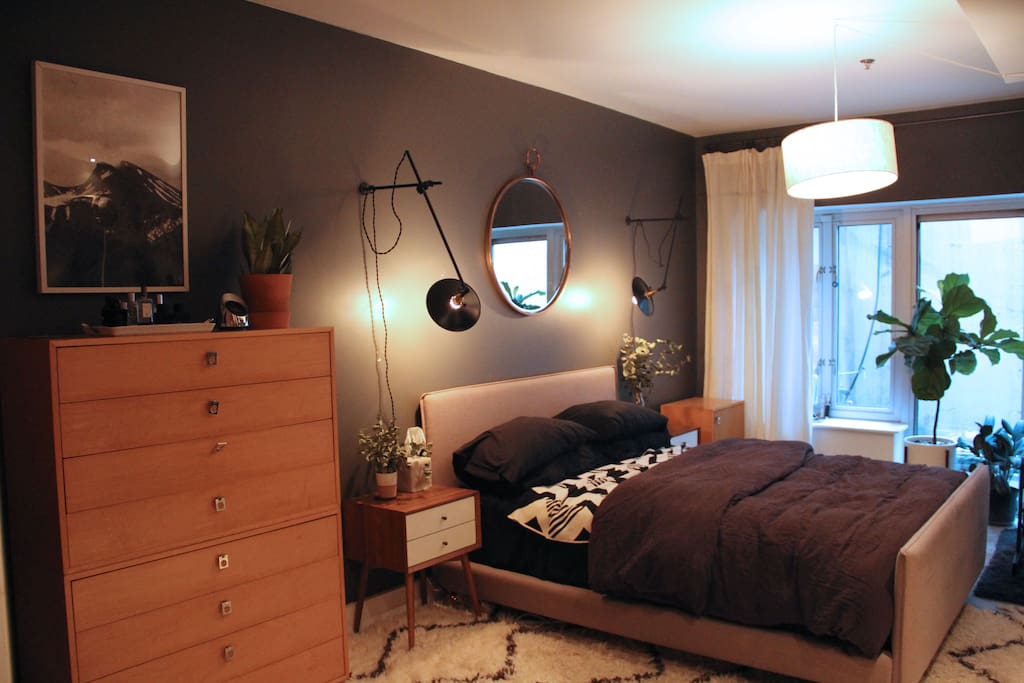 Large master bedroom with Queen size bed on lower level, adjacent to half bathroom and outdoor patio.