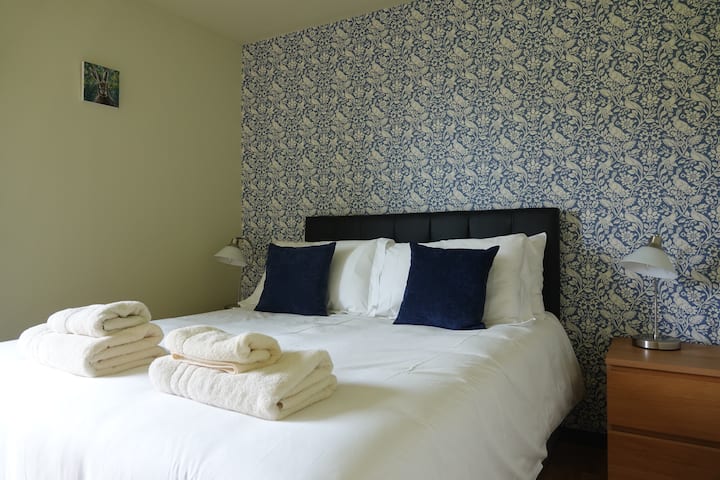 The downstairs kingsize bedroom.  It has a door to the garden and views of the loch and mountains.