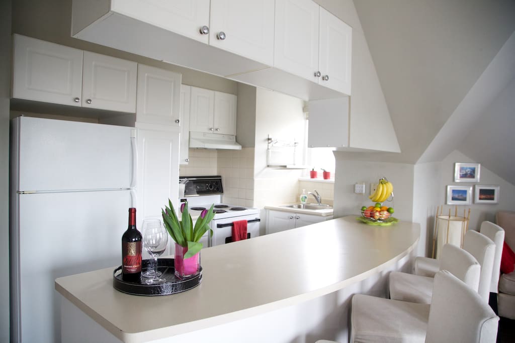 Open concept kitchen and living room with sit up bar...
