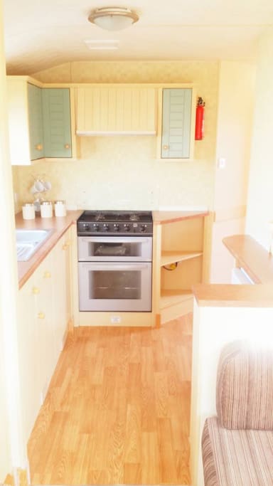 Kitchen area with cooker, microwave, toaster and kettle