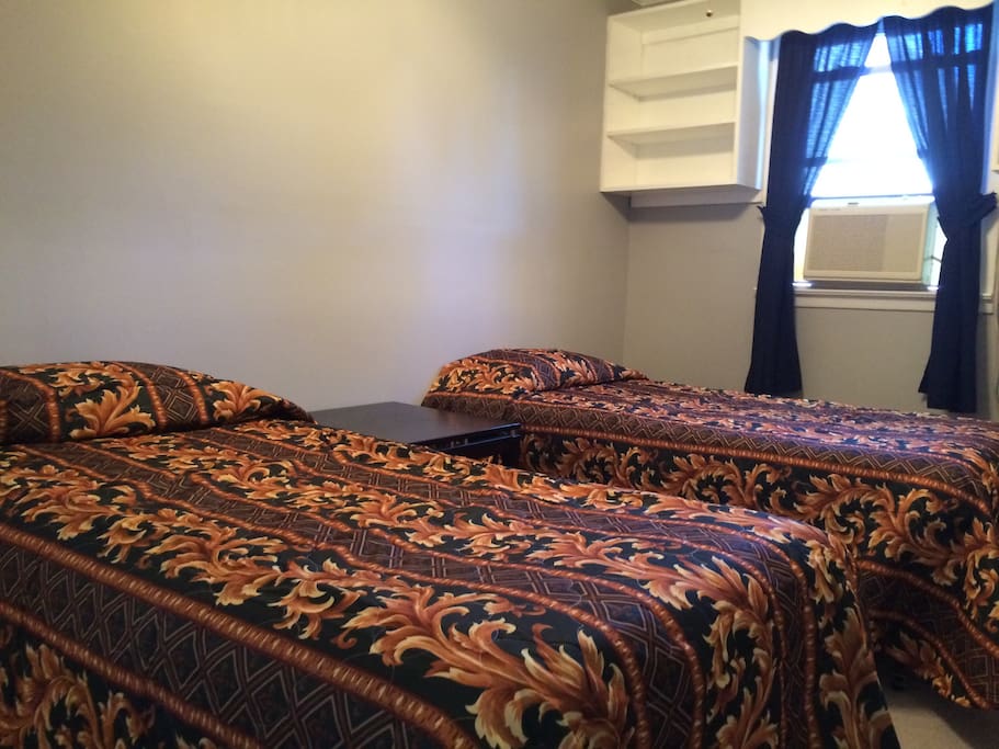 Bedroom one features two twin beds and closet space.