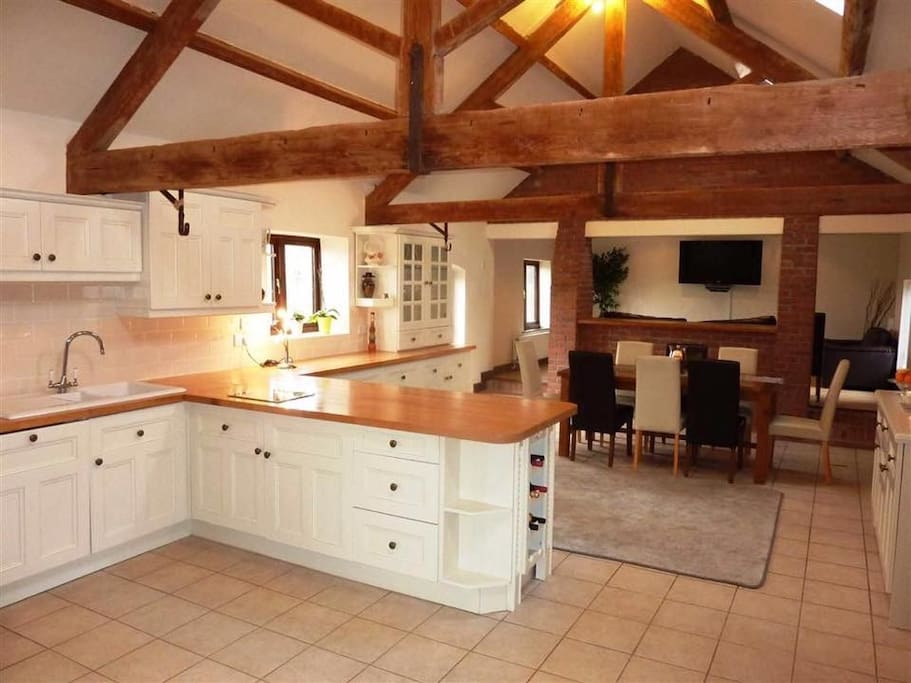 Large kitchen with open beamed ceiling. Lots of character.