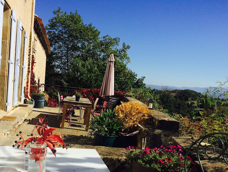 South facing terrace along the back of the house, with views of vines and hills.