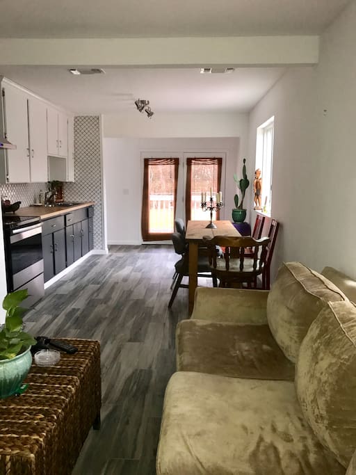 Kitchen has stove, sink, plates, cups, pots-everything to cook/eat. No fridge