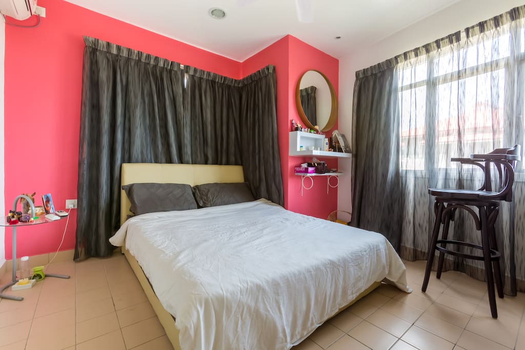 Master bedroom with 1 queen size bed, 1 wardrobe, dressing area and an attached bathroom with heater. The room comes with air-conditioning and fan