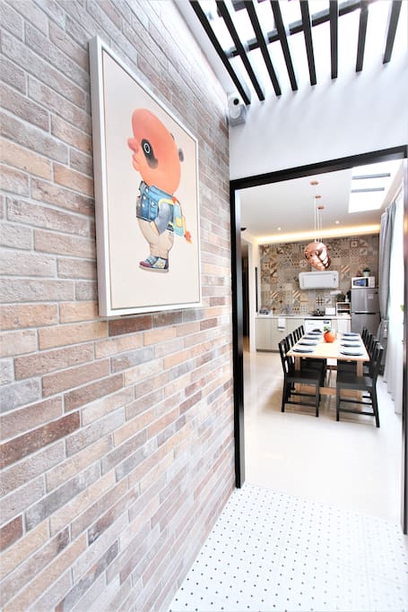 Entry way - Chic black/white floor tiles, craftstone bricks and ceiling louvers. A modern interpretation of traditional Peranakan heritage houses!