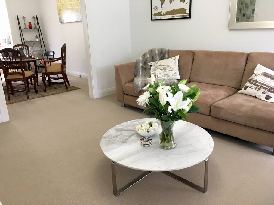 Lounge room, looking into large dining room and modern kitchen / laundry