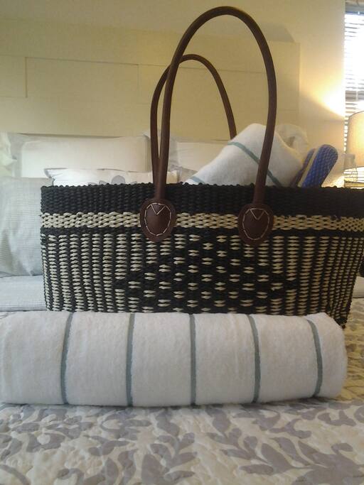 Beach bag provided with towels, sunscreen & paddle ball!