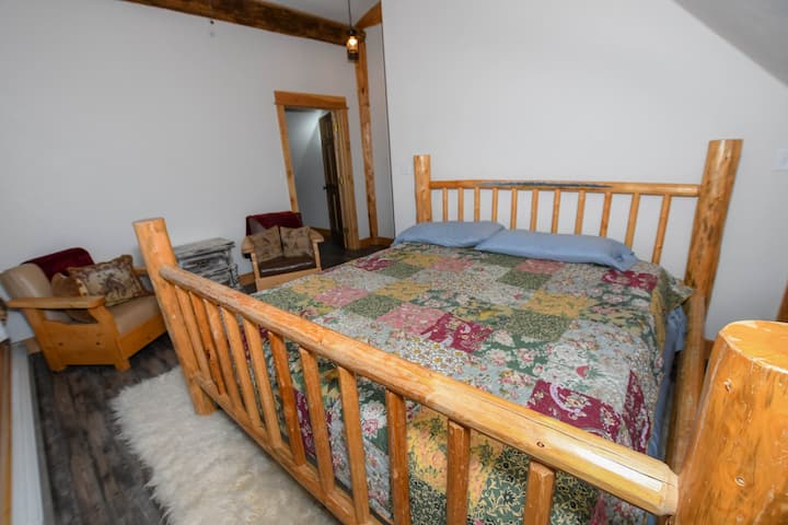 Open king Bedroom with sitting area  with mountain and river views on second floor