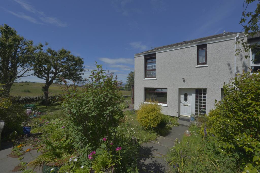 Front of the house, with free parking in drive and large garden.