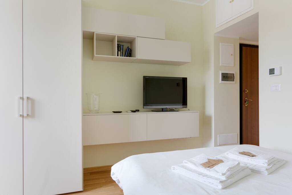 The living room| the Bedroom: the comfortable double sofa bed with soft bed-linen and towels & the equipped kitchen (+ the dining table, TV)