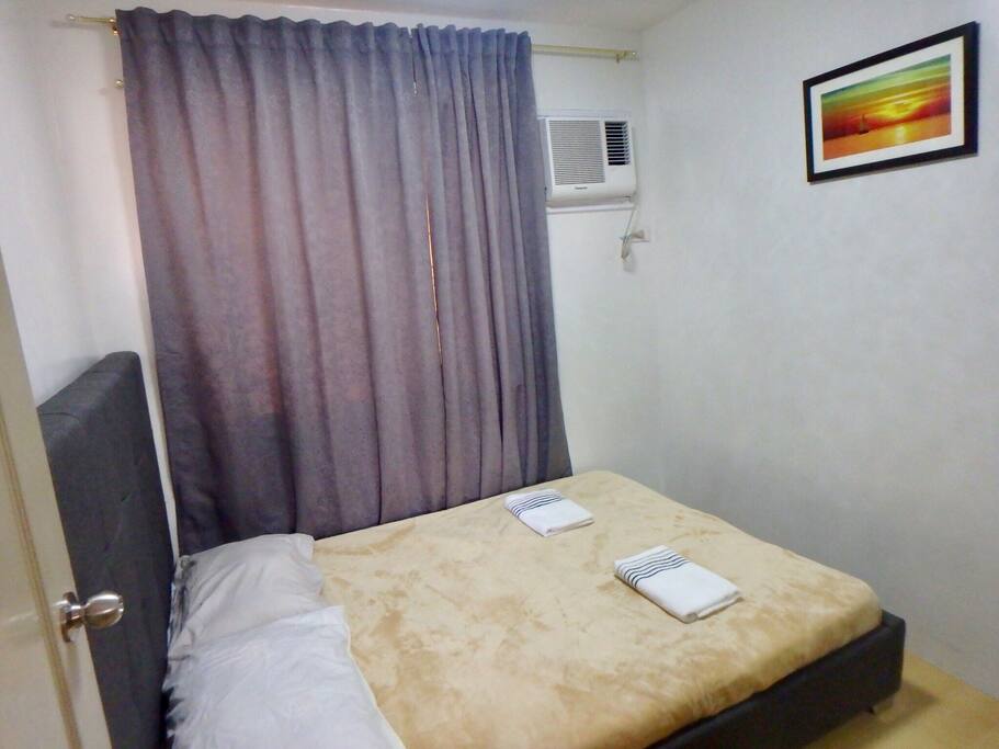Bedroom 1: Queen sized bed with air conditioning and a built-in wardrobe