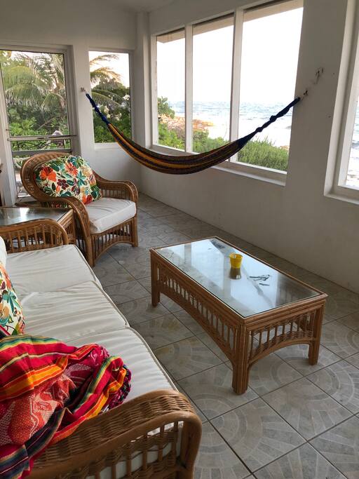 Screened in porch off the den and master bedroom with a hammock and couch for napping!