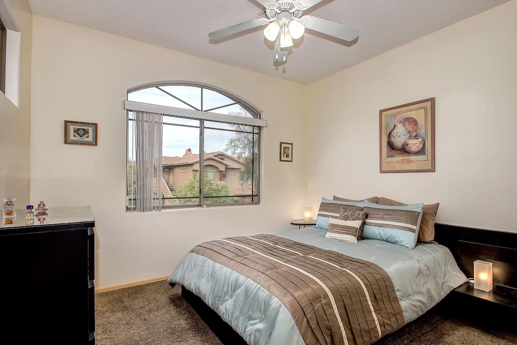 Queen bed with large closet, dresser and overhead fan