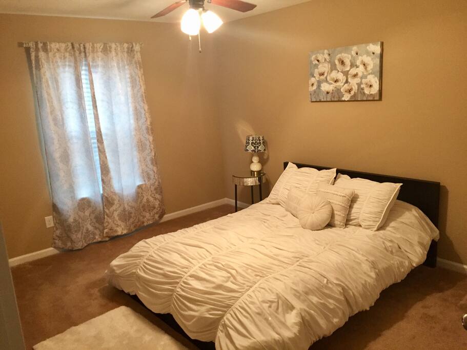 Private bedroom with queen sized bed and closet for storage.