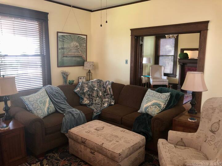 The living room & dining room are open to each other but can be closed off by sliding the pocket doors (original to the house) shut. The living room can also be closed off from the foyer so it becomes a private room. The sofa is very comfy!