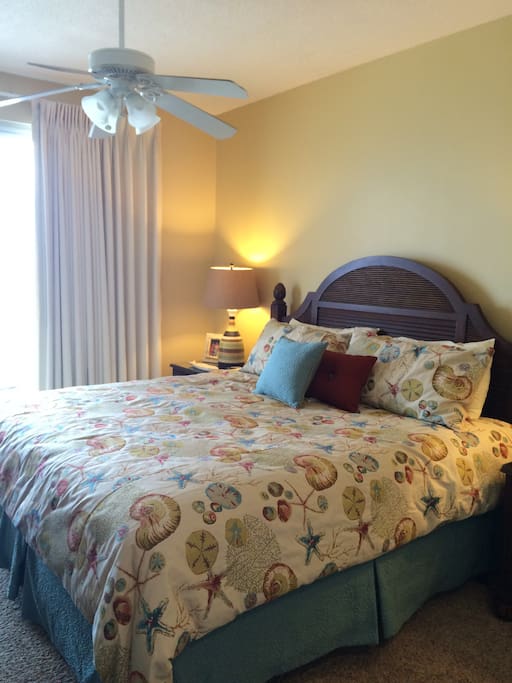 Ocean view master bedroom with king bed and adjoining bath