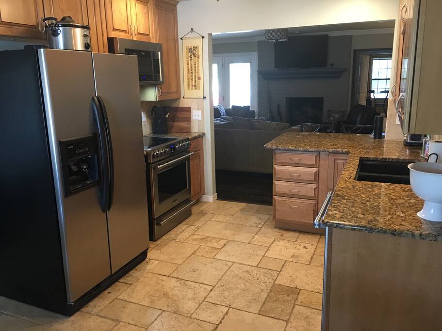 Open-concept kitchen with all new appliances and a granite countertops.