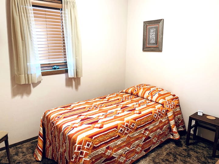 Upstairs bedroom with 1 single bed and closet.