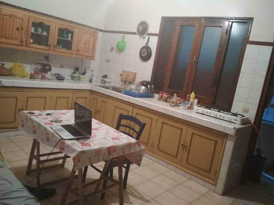 Kitchen with Balcony, Washing Machine, Table and Sofa