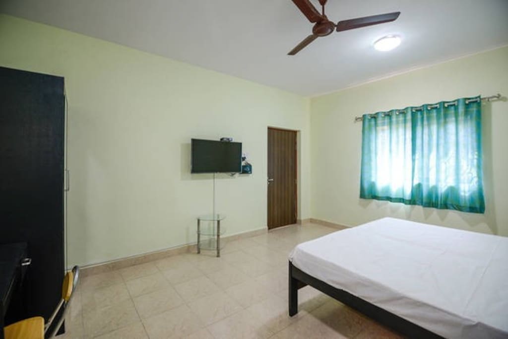 Bedroom has cupboard, sidetable, computer table
