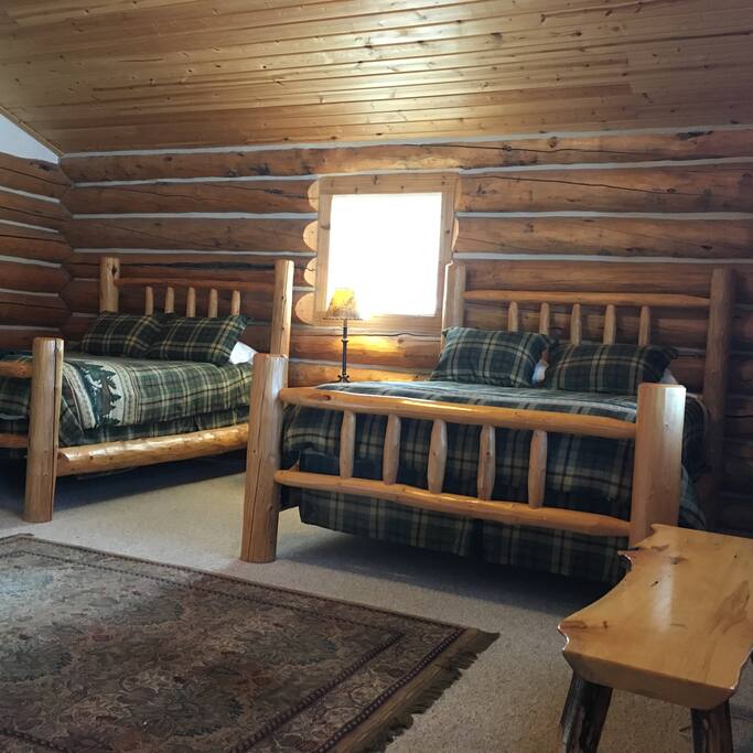 Two queen log beds in a spacious log cabin