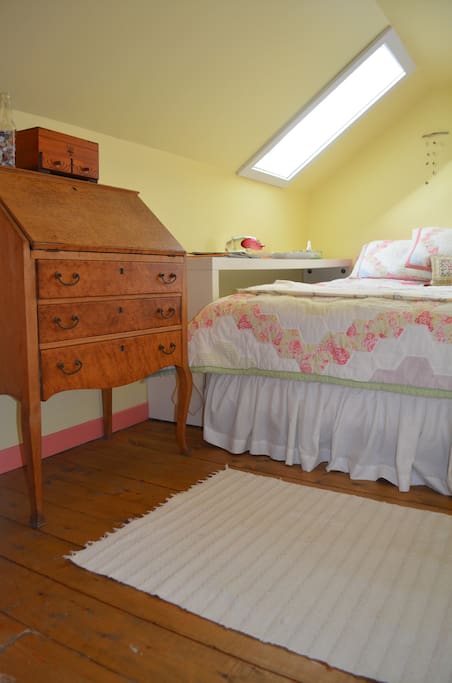 Yellow Bed Room (queen) with skylight and window.