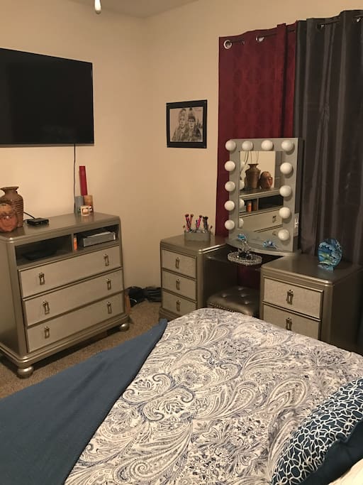 Master bedroom with vanity and entertainment dresser