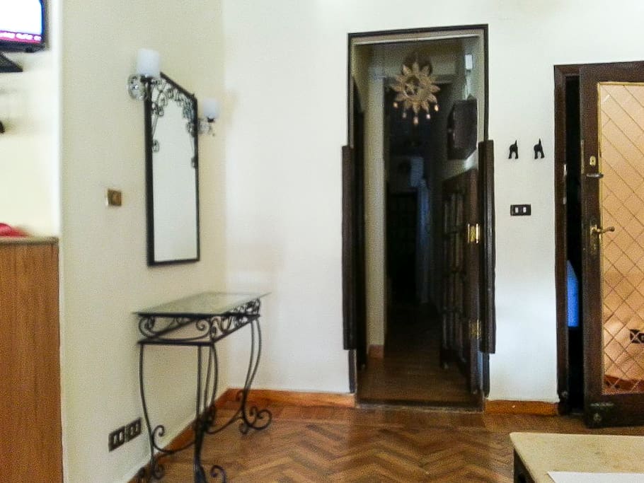 The hall next to the door leading to the three bedrooms and bathroom.