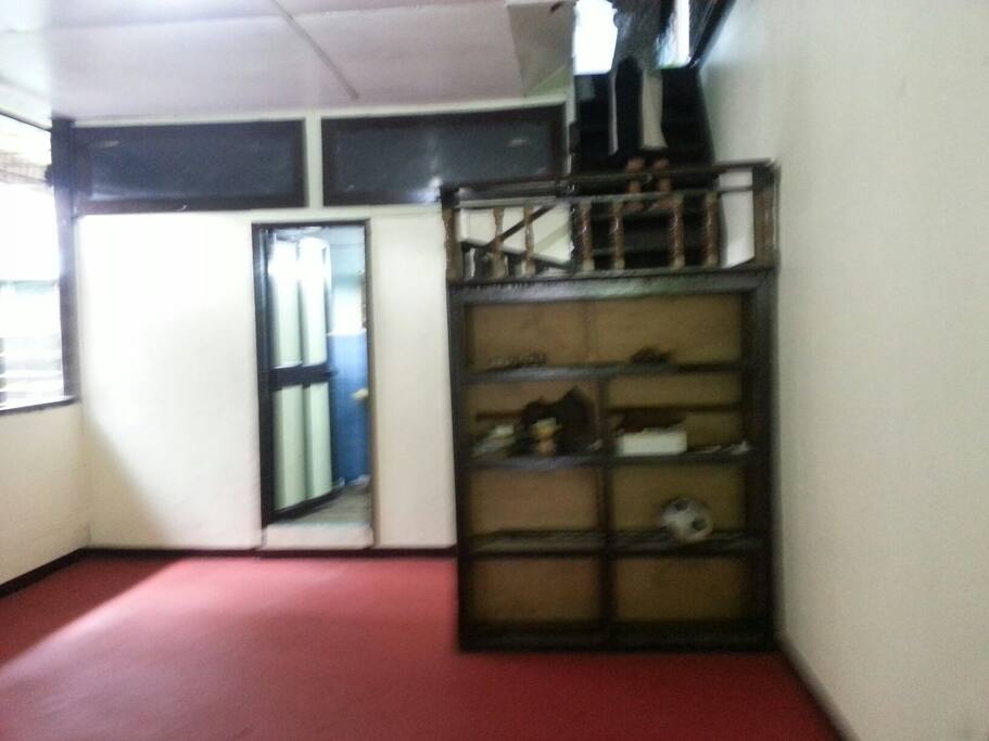 Common area on second floor. Door to bath and toilet on second floor. Stairway to third bedroom.