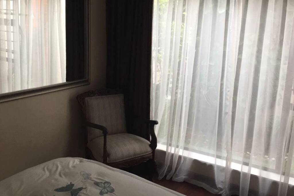 Very bright, luxury room, with queen size bed, side table with side lamp and lots of cupboard space.