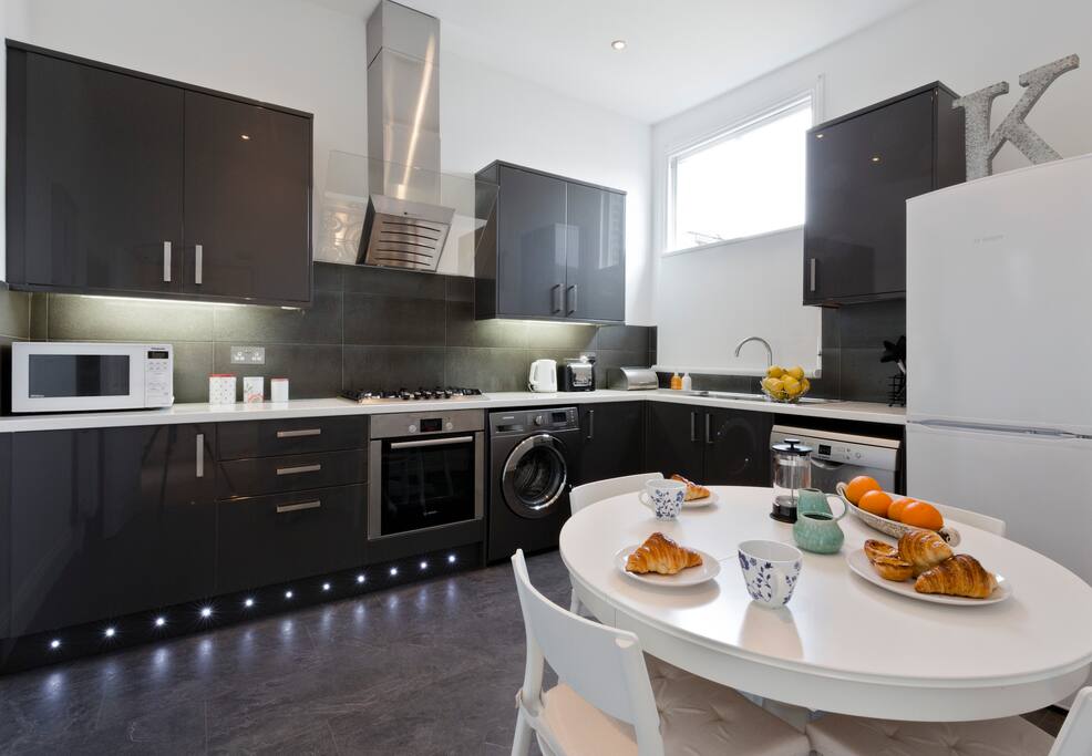 Kitchen with oven, gas hob, fridge freezer, microwave, washing machine, dishwasher