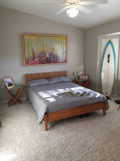 The bedroom is clean and light with a view of Sykes Creek
