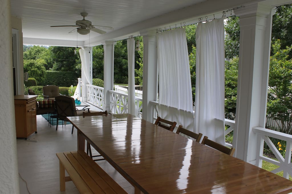 Huge covered porch with dining table for 12+ and sitting area