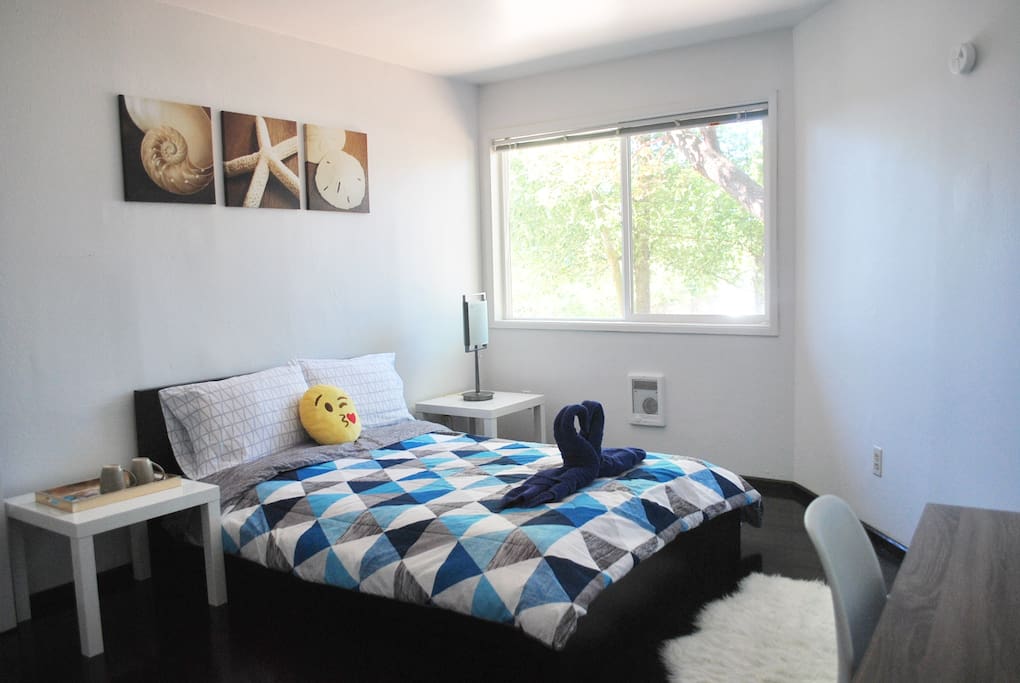 Full-size bed comfortable for 2 adults. The room also has 2 night stands, faux fur sheep rug, and bedside lamp