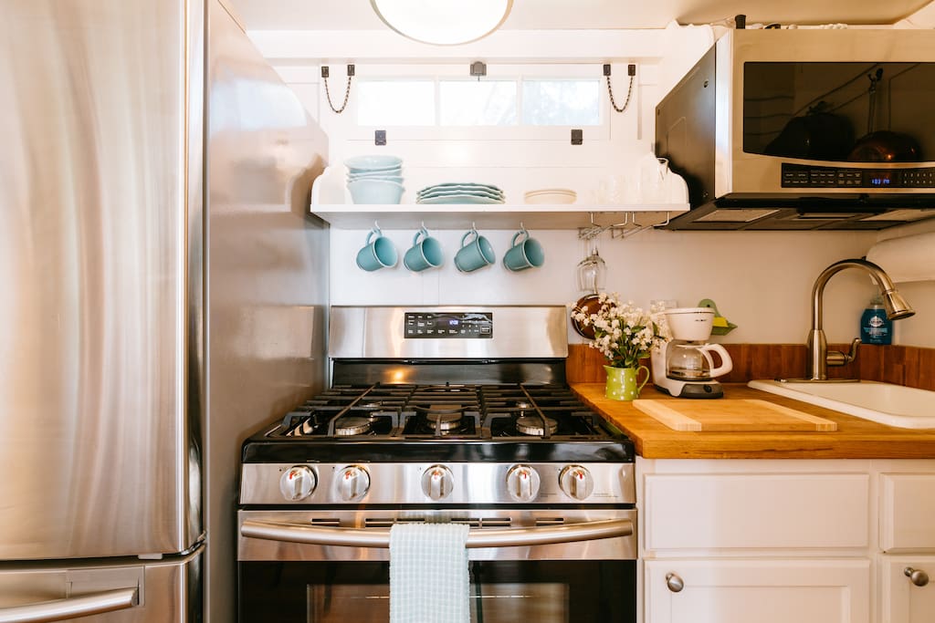 The fully equipped kitchen offers stainless steel range, refrigerator and microwave oven