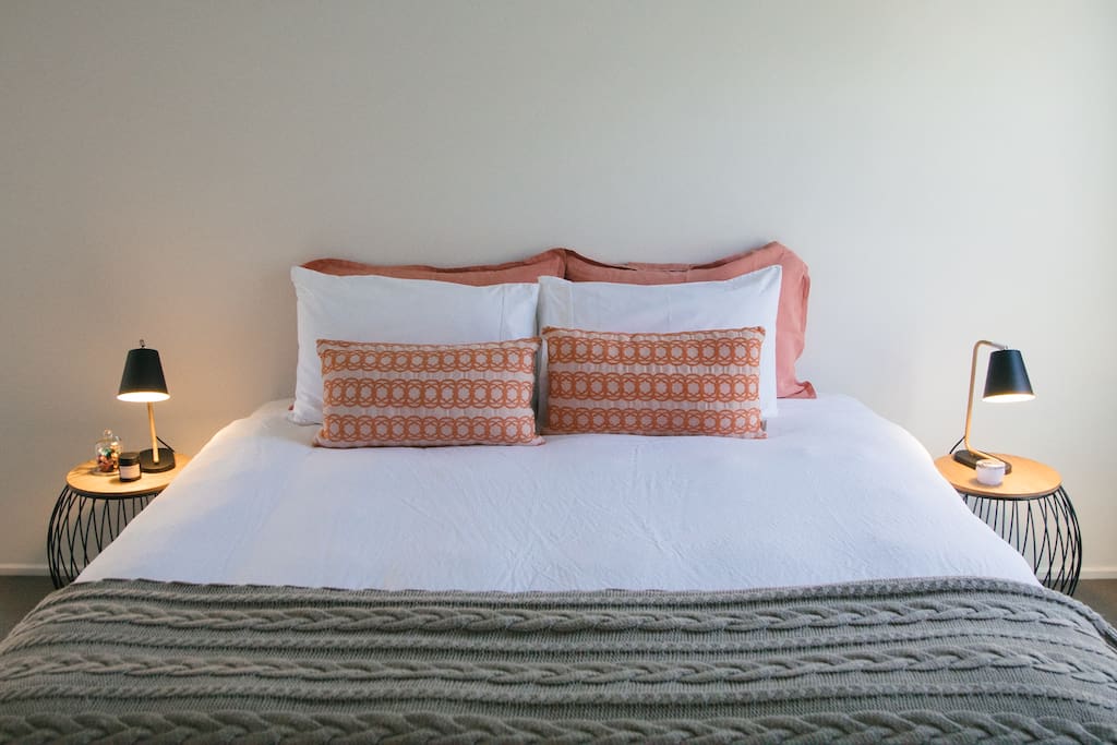 King size bed with crisp white cotton sheets & French Flax duvet cover