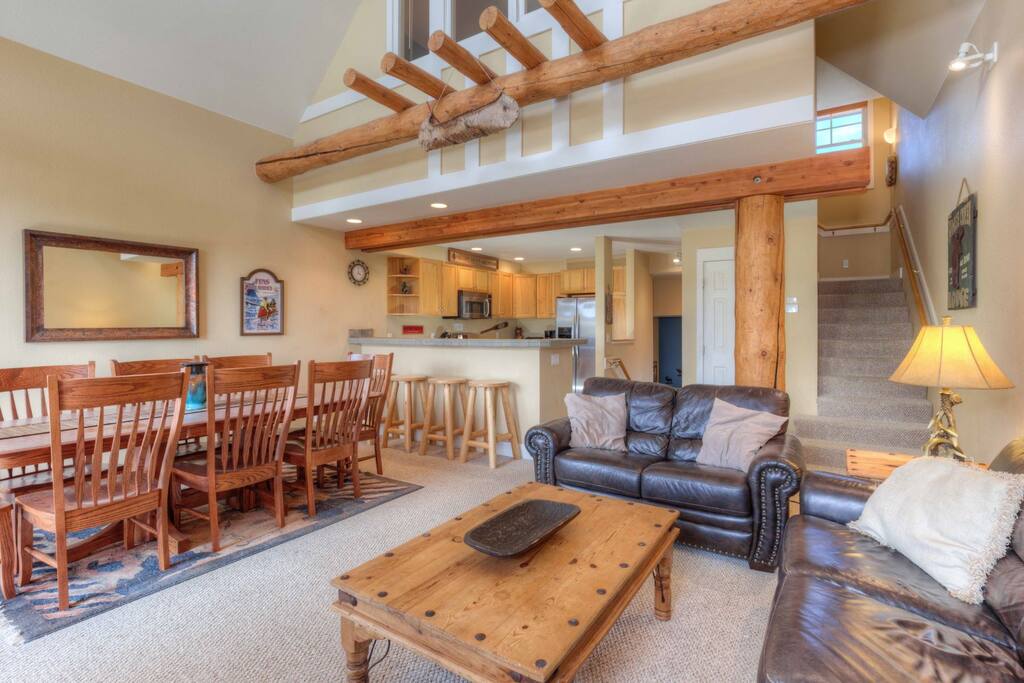 Living room opens to dining, deck, views, and kitchen.