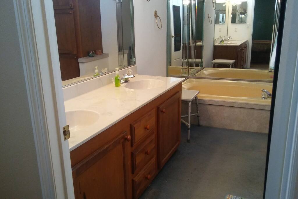 Private bathroom with garden tub and double sinks.